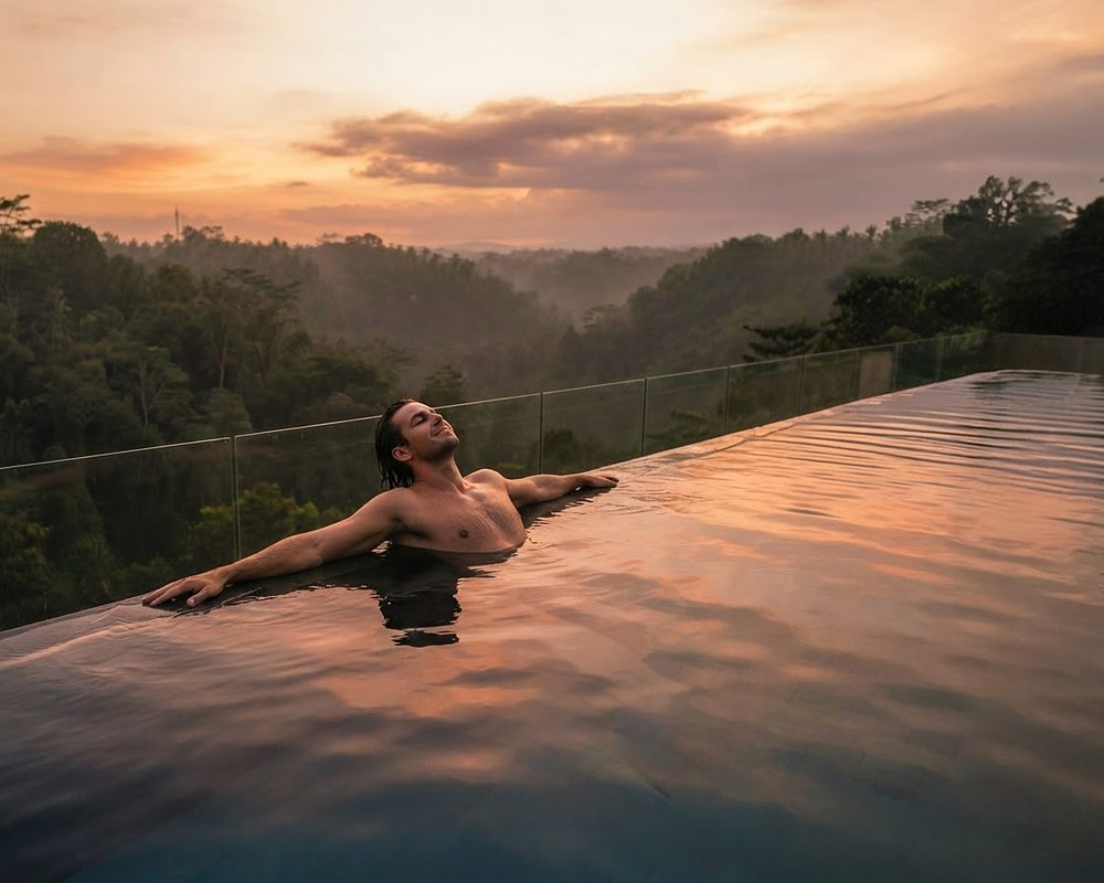 Infinity pool overlooking the forest at sunset (artistic impression)